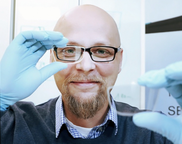 Dispelix co-founder and CEO Antti Sunnari with a sample of the display.