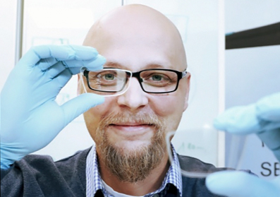 Dispelix co-founder and CEO Antti Sunnari with a sample of the display.