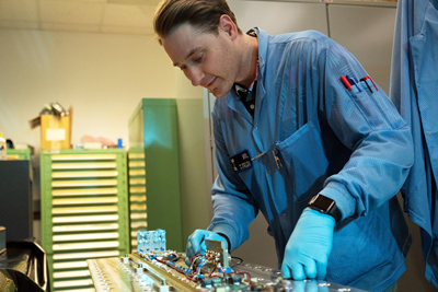 NRL engineer Zachary Kaldy inspects the Space Wireless Energy Laser Link.