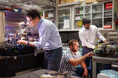 Sandia scientists prepare a rubidium cold-atom cell for an interferometry experiment.